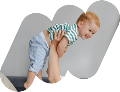 Adult lifting infant smiling