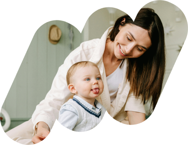 Adult with infant smiling