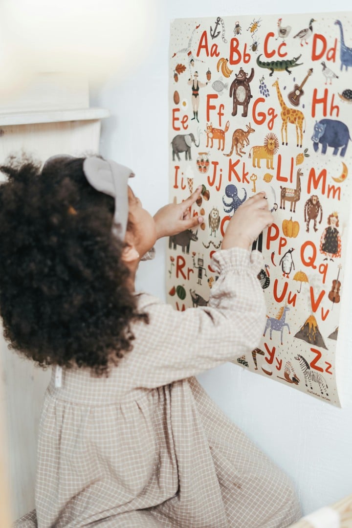 Young child reading the alphabet