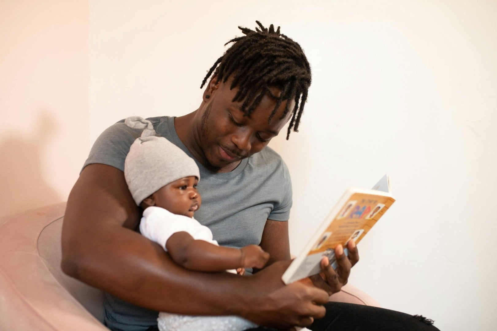 Adult reading book to infant
