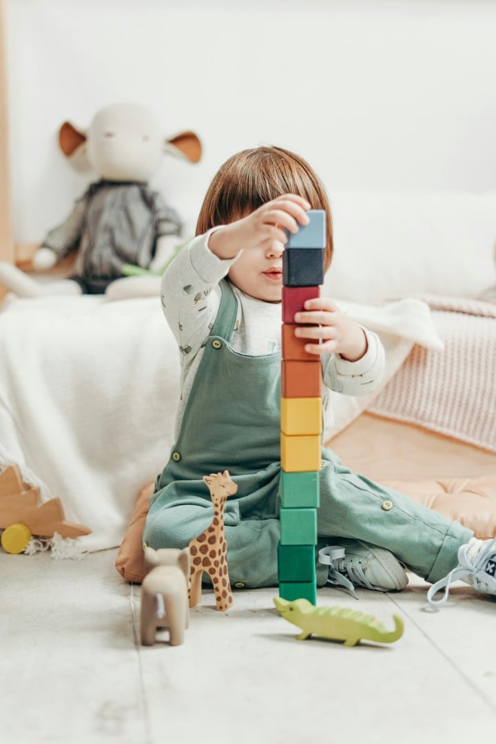 Child stacking wooden blocks
