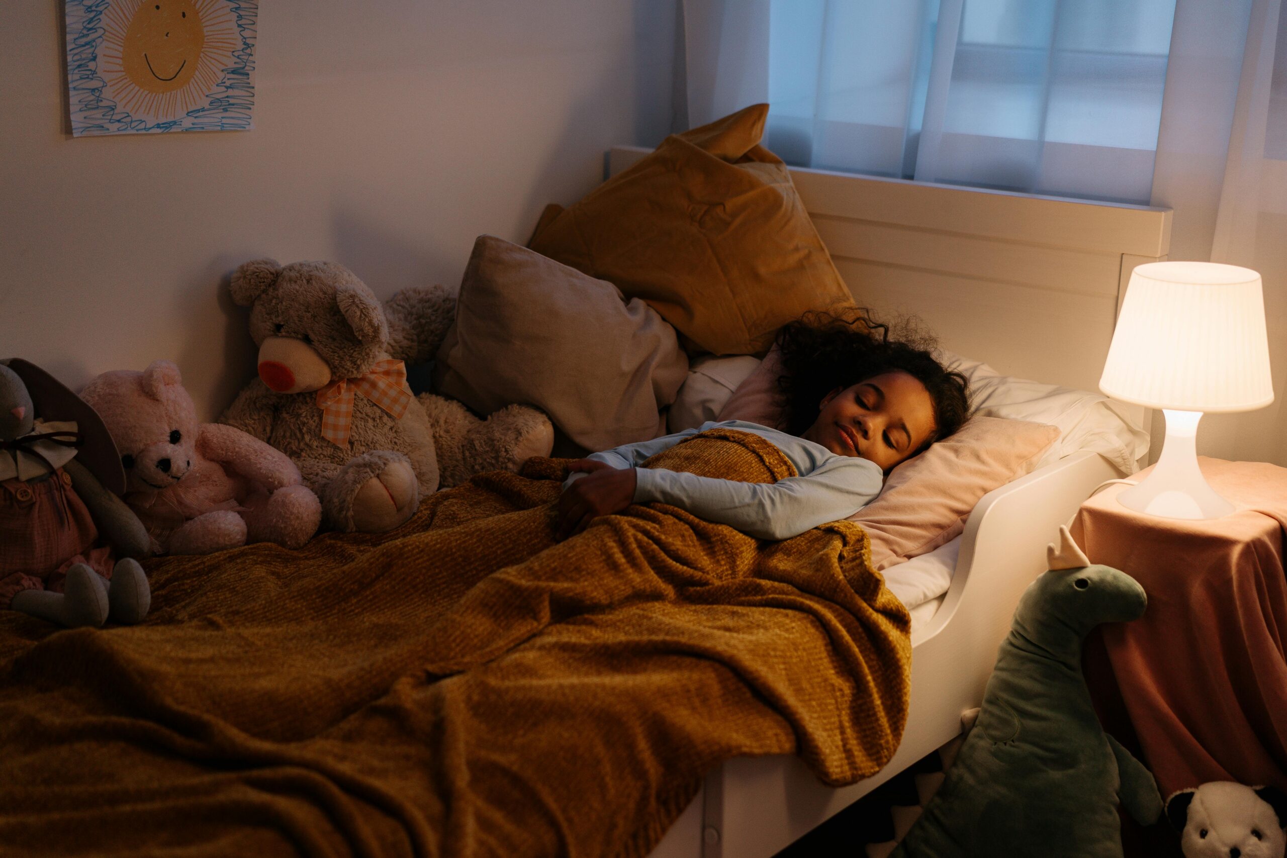 A child peacefully sleeping after using natural sleep remedies, such as a magnesium-rich bedtime routine.