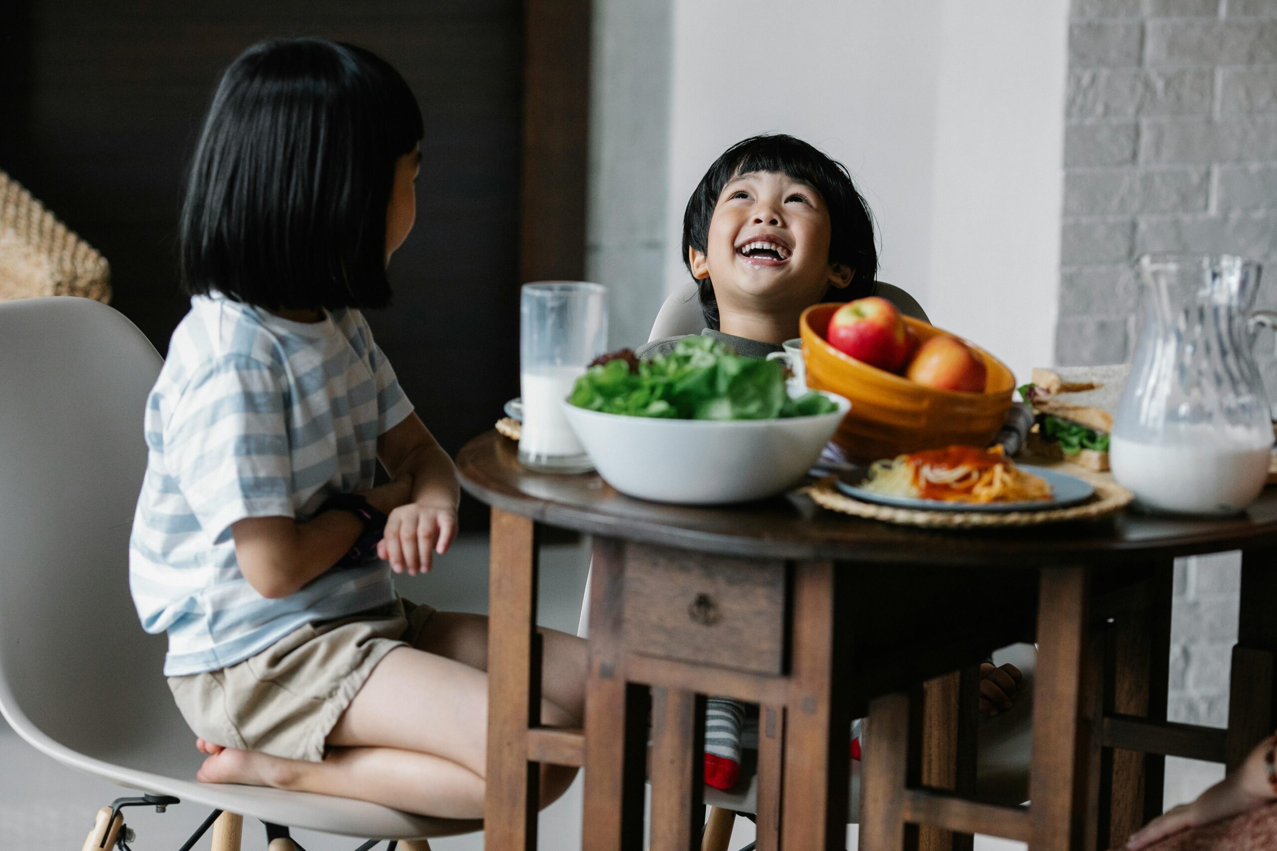 Two kids at the breakfast table