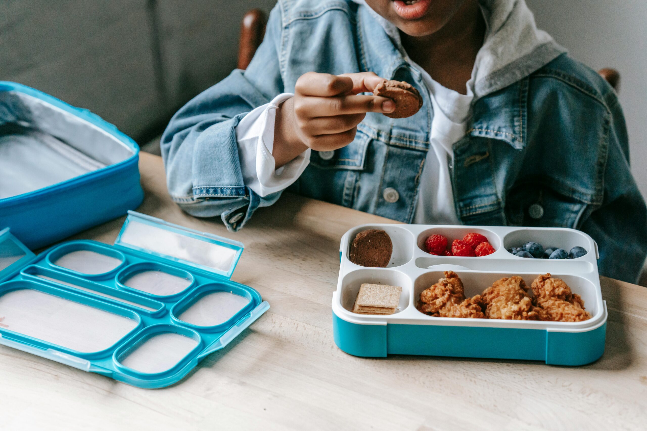 Child eating lunch from a bento box