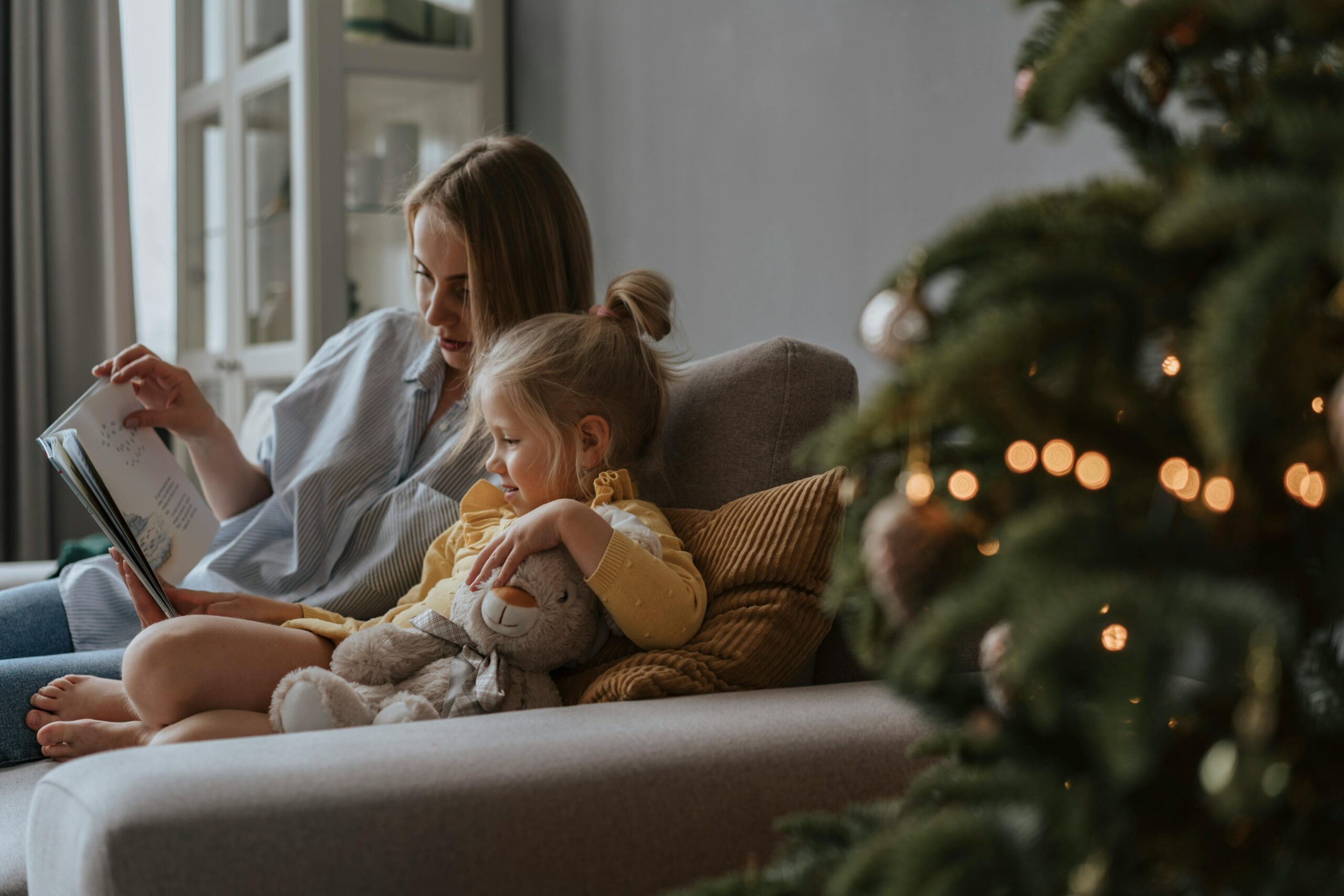 Mother reading to child on the sofa