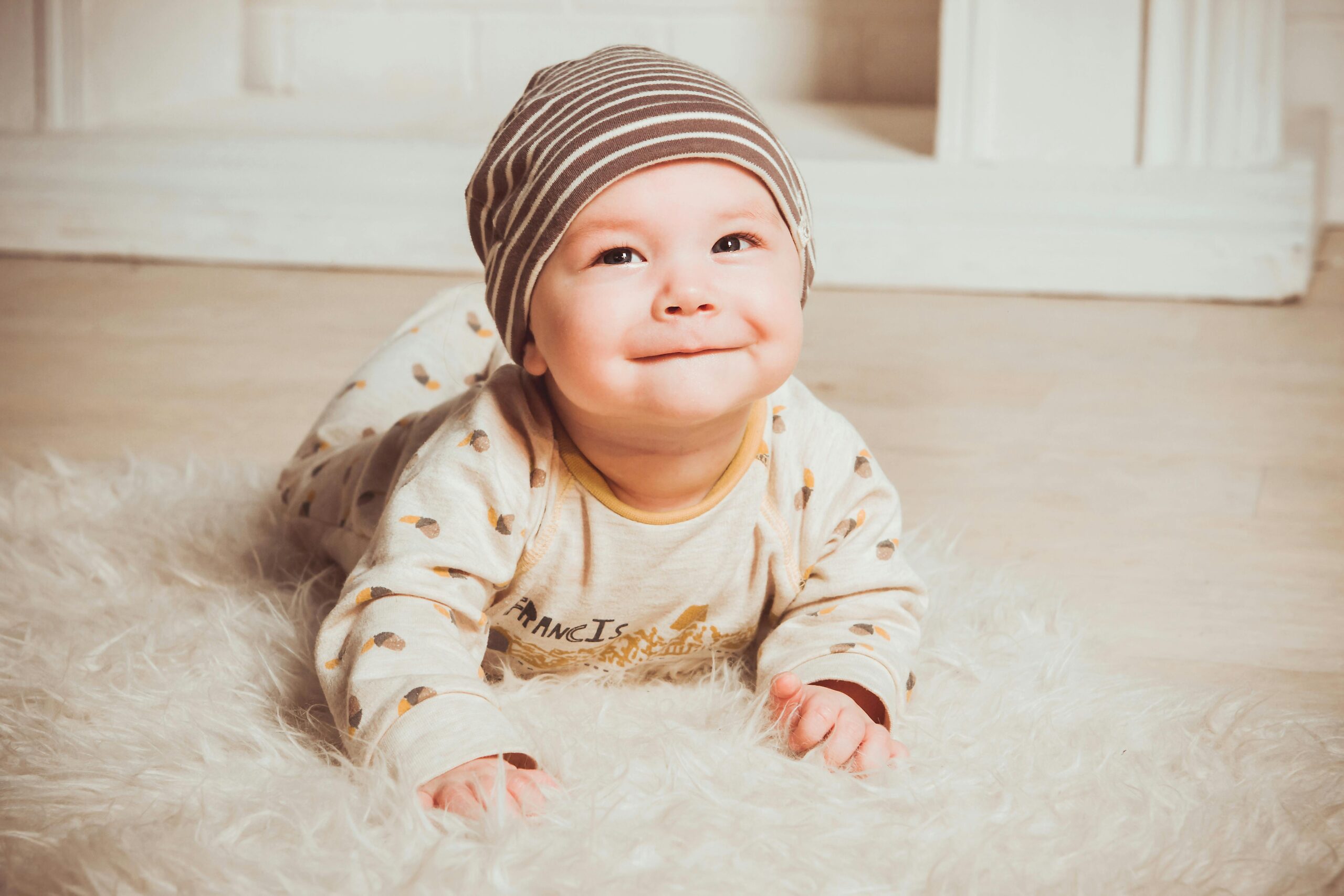 Smiling infant on a shag rug